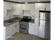 Bright kitchen with white cabinets, stainless steel appliances, and granite counters at 4418 N 34Th Dr, Phoenix, AZ 85017