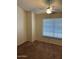 Bright bedroom featuring carpet, ceiling fan, and a large window at 4601 N 102Nd Ave # 1100, Phoenix, AZ 85037