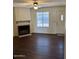Cozy living room featuring a fireplace, ceiling fan, and natural light at 4601 N 102Nd Ave # 1100, Phoenix, AZ 85037