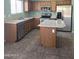 Kitchen with stainless steel appliances, island, and wood cabinets at 11363 W Locust Ln, Avondale, AZ 85323