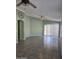 Spacious living room with tile flooring, ceiling fan, and sliding glass doors at 11363 W Locust Ln, Avondale, AZ 85323