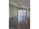 Bright living room with vaulted ceilings, ceiling fan, and sliding glass doors at 11363 W Locust Ln, Avondale, AZ 85323
