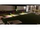 A backyard with a light-up lawn, game area, and hanging canopy bed to enjoy outdoor living at 127 E Pershing Ave, Phoenix, AZ 85022