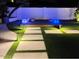 Charming backyard design with artificial turf and illuminated cubes on a wooden deck at 127 E Pershing Ave, Phoenix, AZ 85022