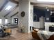 Spacious living room featuring vaulted ceilings, exposed beams, brick fireplace, and modern furnishings at 127 E Pershing Ave, Phoenix, AZ 85022