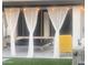 Relaxing patio with an outdoor hanging canopy bed, seating, and lush backyard grass at 127 E Pershing Ave, Phoenix, AZ 85022