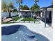 Stylish backyard with a sparkling blue-tiled pool, a lounging area and modern landscaping at 127 E Pershing Ave, Phoenix, AZ 85022