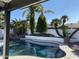 Inviting pool surrounded by palm trees and a rock waterfall feature at 127 E Pershing Ave, Phoenix, AZ 85022
