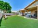 Spacious backyard featuring green artificial turf and covered patio at 1347 W Straford Ave, Gilbert, AZ 85233