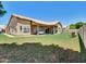 Expansive backyard featuring a covered patio, lush lawn, and desert landscaping at 1347 W Straford Ave, Gilbert, AZ 85233