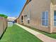 Lush backyard with a manicured lawn and walkway at 1347 W Straford Ave, Gilbert, AZ 85233