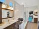 Modern bathroom with a marble-walled shower, stylish vanity, and adjacent salon chair at 1347 W Straford Ave, Gilbert, AZ 85233