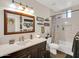 Bathroom with a marble countertop, framed mirror, stylish shower curtain, and ample lighting at 1347 W Straford Ave, Gilbert, AZ 85233