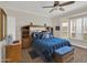Bedroom featuring a blue bed, a window with blinds, wood flooring and a bookshelf headboard at 1347 W Straford Ave, Gilbert, AZ 85233