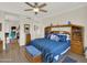 Bedroom showcasing a blue bed with storage, ceiling fan, and views into adjacent living spaces at 1347 W Straford Ave, Gilbert, AZ 85233