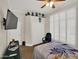 Bedroom featuring a ceiling fan, a decorative dresser, a wall-mounted TV, and closet space at 1347 W Straford Ave, Gilbert, AZ 85233