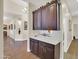 Hallway showcasing a built-in cabinet with granite countertop and white backsplash, flowing into the dining area at 1347 W Straford Ave, Gilbert, AZ 85233