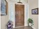 Elegant entryway featuring a solid wood front door with sidelights and decorative trim at 1347 W Straford Ave, Gilbert, AZ 85233