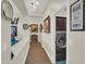 Hallway with hardwood floors leading to the laundry room with a modern front-load washer and dryer at 1347 W Straford Ave, Gilbert, AZ 85233