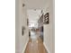 Long hallway with shiny wood-look flooring that provides views of the living area and built-in cabinets at 1347 W Straford Ave, Gilbert, AZ 85233
