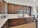 A modern kitchen features stainless steel appliances, wood cabinets, and lots of countertop space at 1347 W Straford Ave, Gilbert, AZ 85233