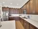 A bright kitchen features stainless steel appliances, wood cabinets, and ample counter space at 1347 W Straford Ave, Gilbert, AZ 85233