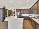 An open-concept kitchen boasts a large island, stainless steel appliances, and wood cabinets at 1347 W Straford Ave, Gilbert, AZ 85233