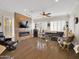 Bright living room includes a stone wall, modern fireplace, plush sectional sofa, and shuttered windows at 1347 W Straford Ave, Gilbert, AZ 85233