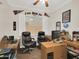 Comfortable home office with a window, ceiling fan, two work desks, and leather office chairs at 1347 W Straford Ave, Gilbert, AZ 85233