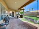 An inviting covered patio with outdoor swing and lush lawn at 1347 W Straford Ave, Gilbert, AZ 85233