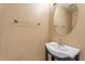 Powder room featuring a pedestal sink with modern fixtures and a vanity mirror at 1520 E Flint St, Chandler, AZ 85225