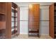 Walk-in closet with custom wood shelving, drawers, and hanging racks for optimal organization at 1520 E Flint St, Chandler, AZ 85225