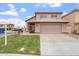 Charming two-story home showcasing a well-manicured lawn, a neutral palette, and a spacious two-car garage at 1520 E Flint St, Chandler, AZ 85225