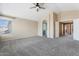 Spacious primary bedroom with carpeting, an arched doorway, and natural light at 1520 E Flint St, Chandler, AZ 85225