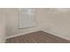 Cozy bedroom featuring a window with white shutters and wood-look flooring at 3109 N Meadow Dr, Avondale, AZ 85392