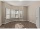 Bedroom with wooden floors and plantation shutters at 3109 N Meadow Dr, Avondale, AZ 85392