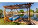 Beautiful waterfront property featuring a private dock with seating and tranquil views at 3109 N Meadow Dr, Avondale, AZ 85392