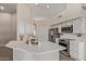 Well-lit kitchen features stainless steel appliances, white cabinetry, and quartz countertops at 3109 N Meadow Dr, Avondale, AZ 85392