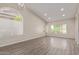 Spacious open-plan living area with large windows, hardwood floors, and modern lighting fixtures at 3109 N Meadow Dr, Avondale, AZ 85392