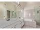Main bathroom features dual sinks, bathtub, and a glass-door shower at 3109 N Meadow Dr, Avondale, AZ 85392