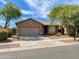 Charming single-story home with a well-manicured front yard, desert landscaping, and a two-car garage at 4119 E Sundance Ave, Gilbert, AZ 85297