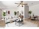 Bright living room featuring neutral décor, a ceiling fan, and an archway to the dining area at 4534 E Beverly Ln, Phoenix, AZ 85032