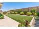 Spacious backyard featuring low maintenance landscaping, lush greenery and a patio at 5962 E Abraham Ln, Phoenix, AZ 85054