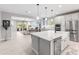 Open-concept kitchen with stainless steel appliances, a large island, and seamless flow to living area at 5962 E Abraham Ln, Phoenix, AZ 85054