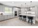 Modern kitchen features white cabinetry, stainless steel appliances, and an island with bar seating at 5962 E Abraham Ln, Phoenix, AZ 85054