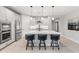 Well-equipped kitchen with white cabinets, stainless steel appliances, and a large island with seating at 5962 E Abraham Ln, Phoenix, AZ 85054