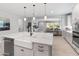 Bright kitchen featuring an island with a farmhouse sink, stainless steel appliances, and pendant lighting at 5962 E Abraham Ln, Phoenix, AZ 85054
