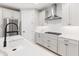 Bright kitchen features stainless steel appliances, white cabinetry, a large island and modern fixtures at 5962 E Abraham Ln, Phoenix, AZ 85054