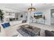 Comfortable living room boasts modern design and an open concept layout leading into the kitchen at 5962 E Abraham Ln, Phoenix, AZ 85054