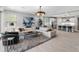 Stylish living room featuring a large sectional sofa, modern decor, and a seamless flow to the kitchen at 5962 E Abraham Ln, Phoenix, AZ 85054